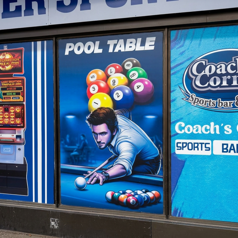 Coach’s Corner Sports Bar & Grill storefront window graphics feature a burger, video games, and a pool player with billiard balls.